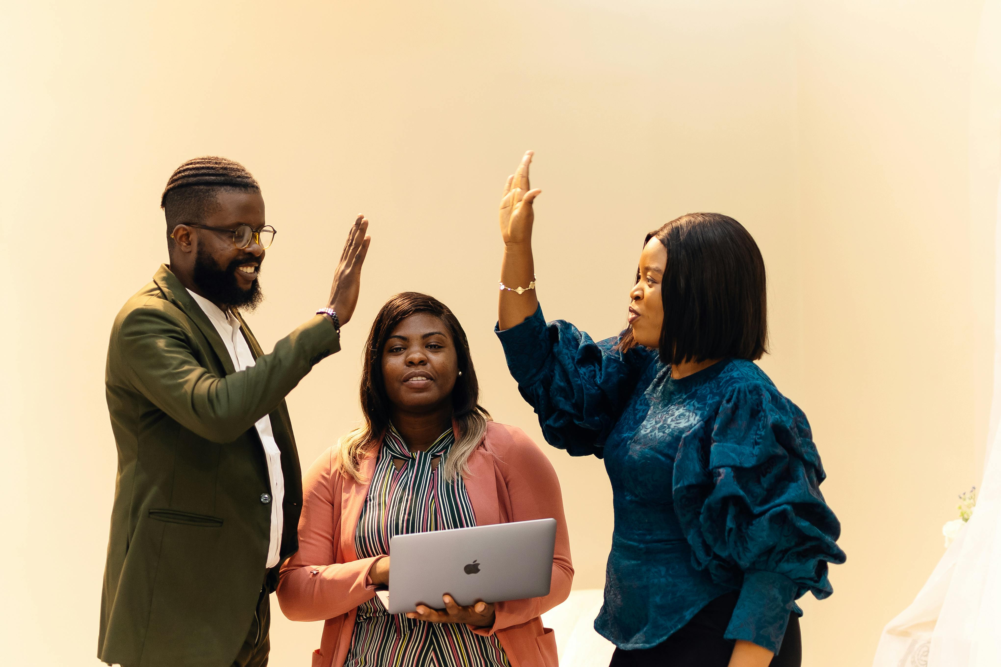 Collaborative Office Team High-Fiving in Lagos